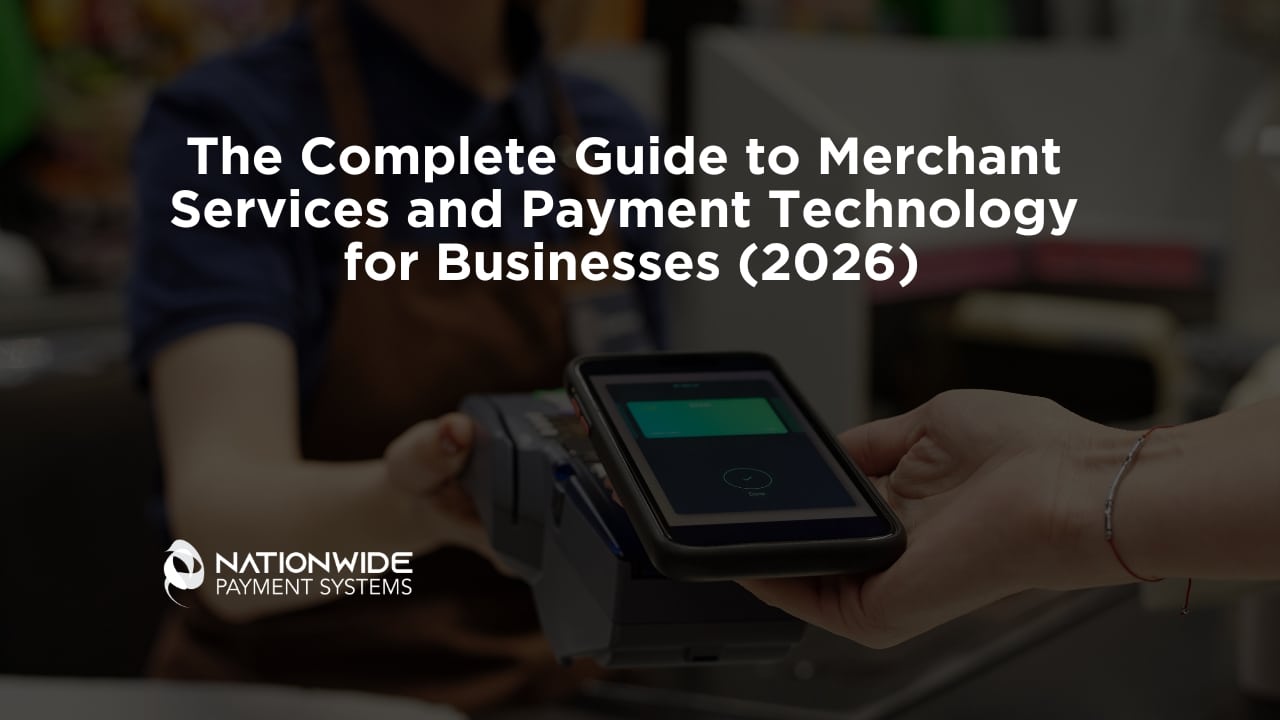 A customer’s hand holding a smartphone over a contactless payment terminal at a checkout counter, with a cashier in a brown apron in the background. Bold white text overlays the scene reading "The Complete Guide to Merchant Services and Payment Technology for Businesses (2026)" alongside the Nationwide Payment Systems logo.