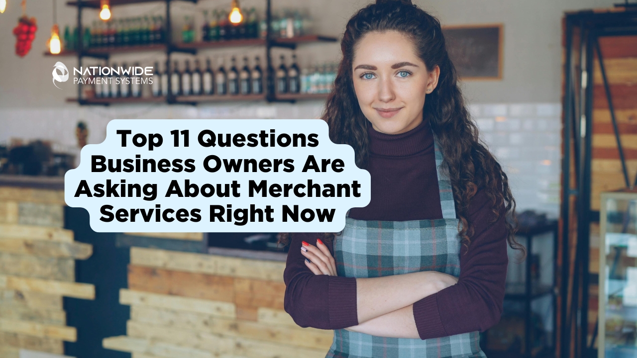 A young woman with long curly hair wearing a plaid apron stands confidently with her arms crossed in a modern cafe or boutique setting. A light blue speech bubble graphic on the left contains the text, "Top 11 Questions Business Owners Are Asking About Merchant Services Right Now," with the Nationwide Payment Systems logo in the top left corner.